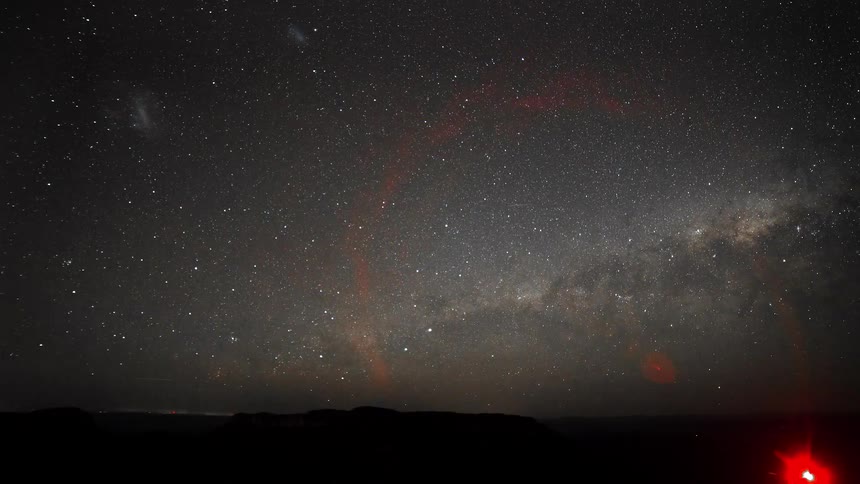 Shooting stars move across a galaxy glowing over the night sky landscape