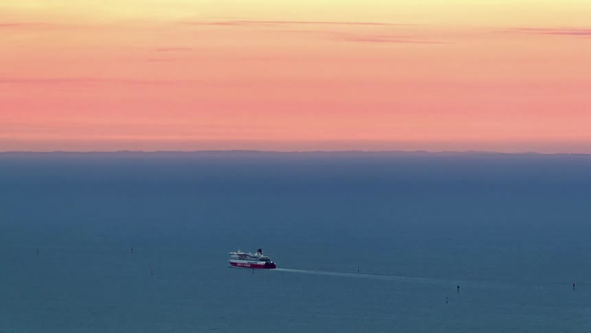 Boat motoring through the sea outdoors during dusk or dawn