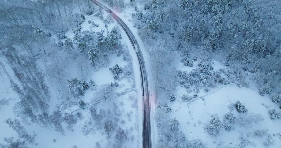 Snowy landscape with winding road through snowcovered trees