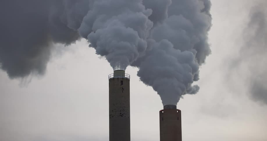 Smoke pouring from factory smokestacks