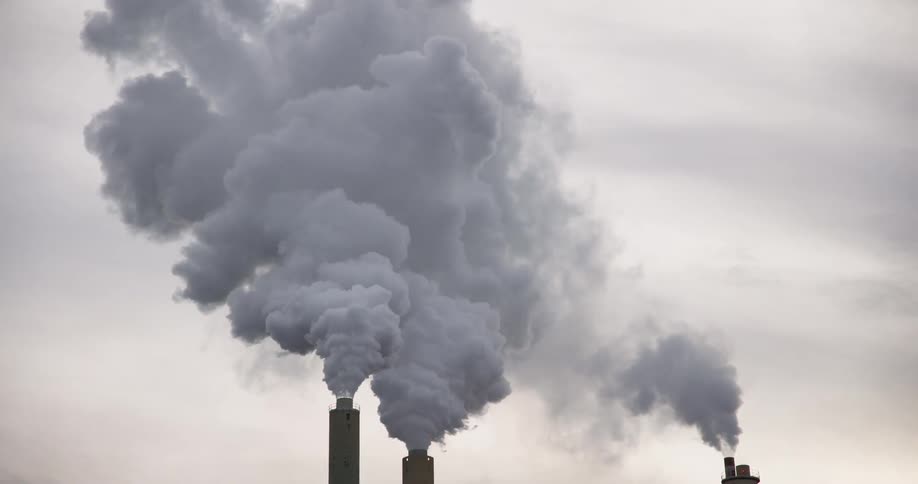 Smoke pouring from factory smokestacks