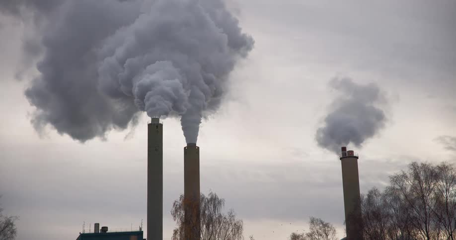 Factories with chimneys releasing pollutants