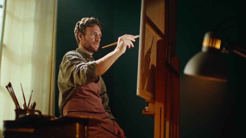 A man painting on a canvas