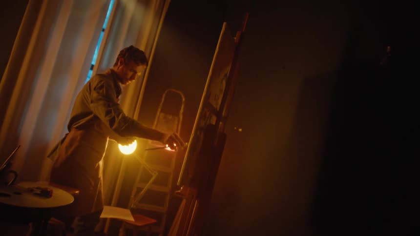 A man painting on a canvas