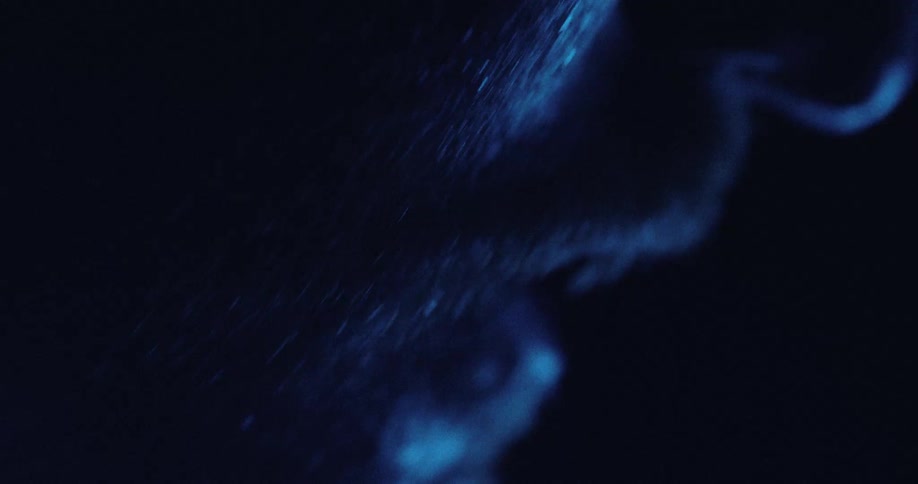 Human profile in closeup under blue lighting with focus on skin texture and nose contour