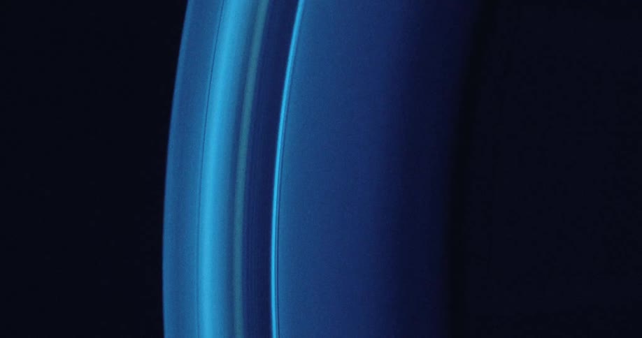 Light shines on a blue wheel with texture on the edge spinning and stopping