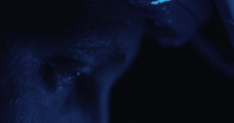 A man riding a bicycle at night with a headlamp
