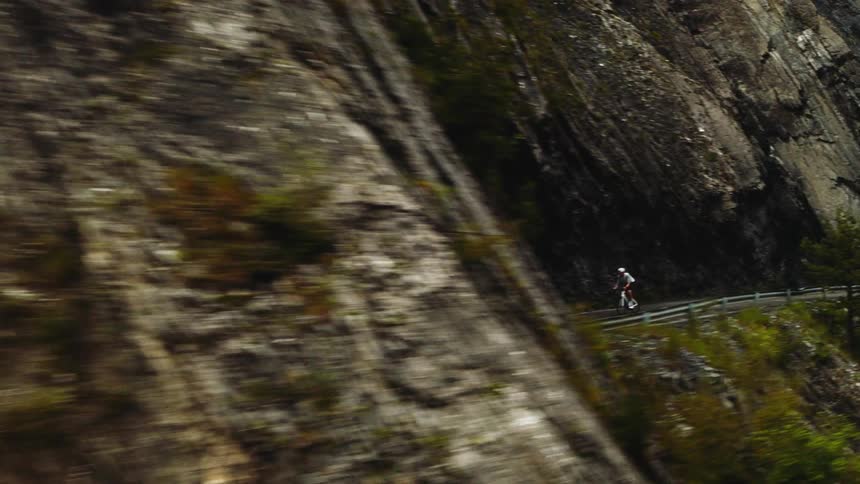 A cyclist riding through the mountains