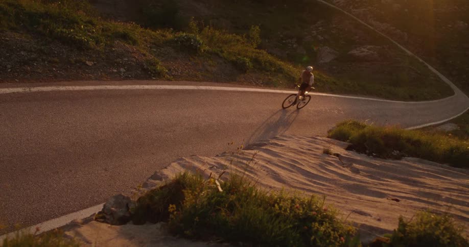 Man pedaling his bicycle up a steep mountain road