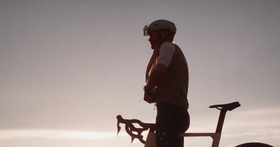 A man on a bike at the top of a mountain