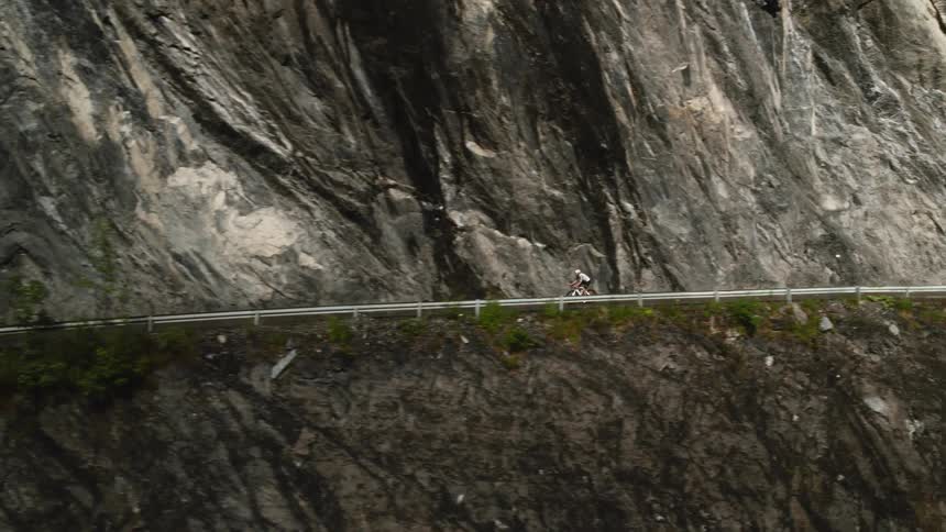 Man riding his bicycle on a mountainside road