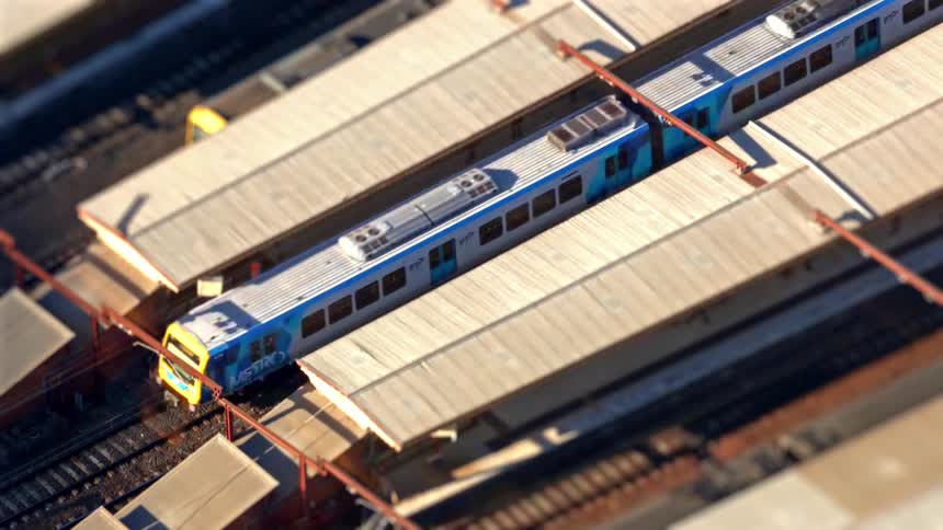 A sped up view of trains leaving a train station