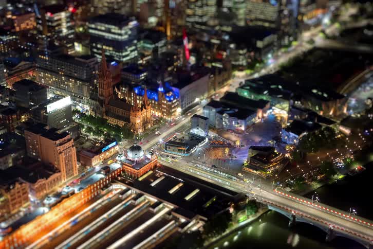 Vibrant city lights and bustling traffic sparkle across the nighttime city