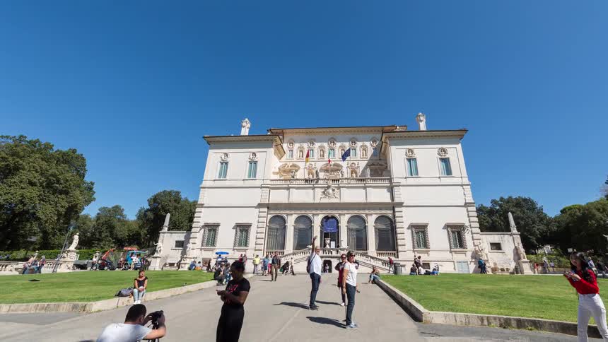A large group of tourists visiting the borghese gallery on a sunny day in the city