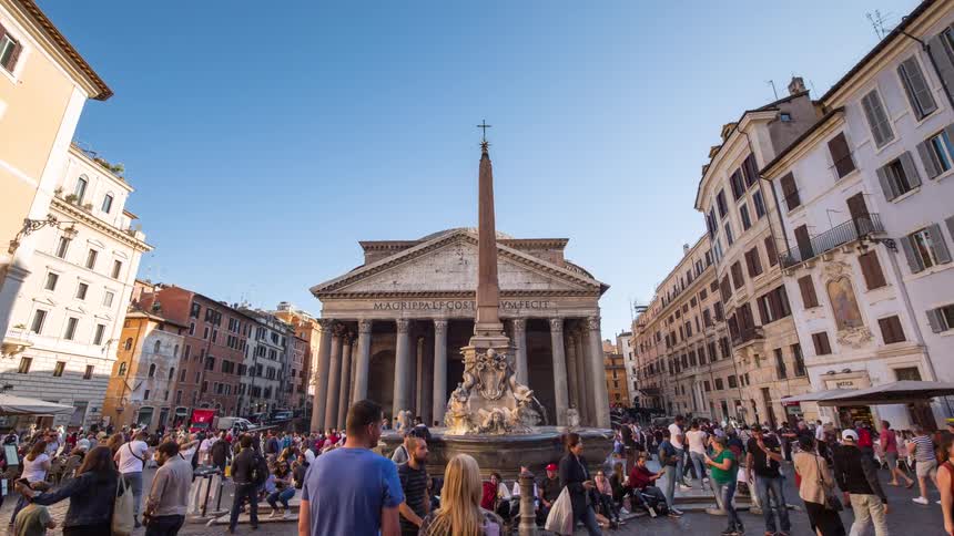 Tourists walk around the monument in the city