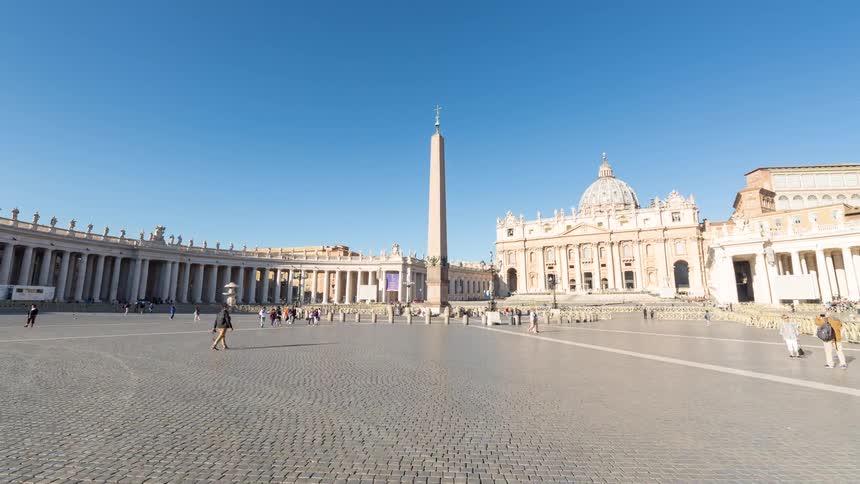 Tourists explore the historic roman forum ruins and st peters square under a clear blue sky