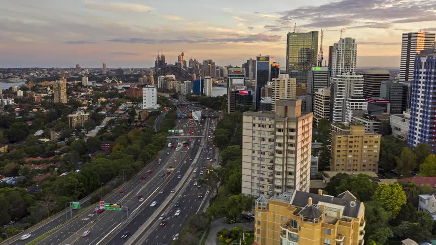 Aerial view of the city center with tall buildings busy expressway and soft evening light