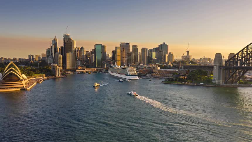 Harbor view with the financial district in the background moving vessels and waterfront landmarks