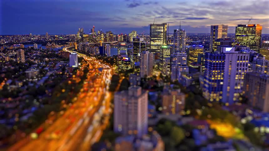 A view of a city with tall buildings and sped up