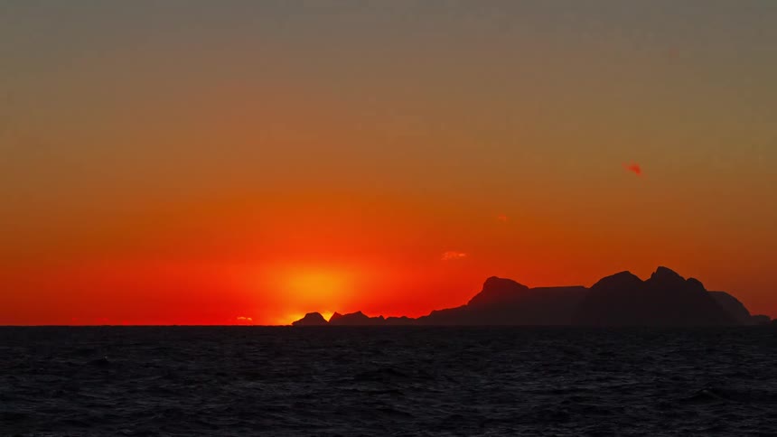 A time lapse of the sun setting over the ocean