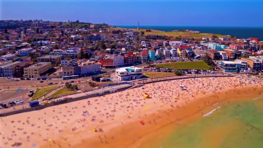 Crowded beach next to an urban area outdoors during day time