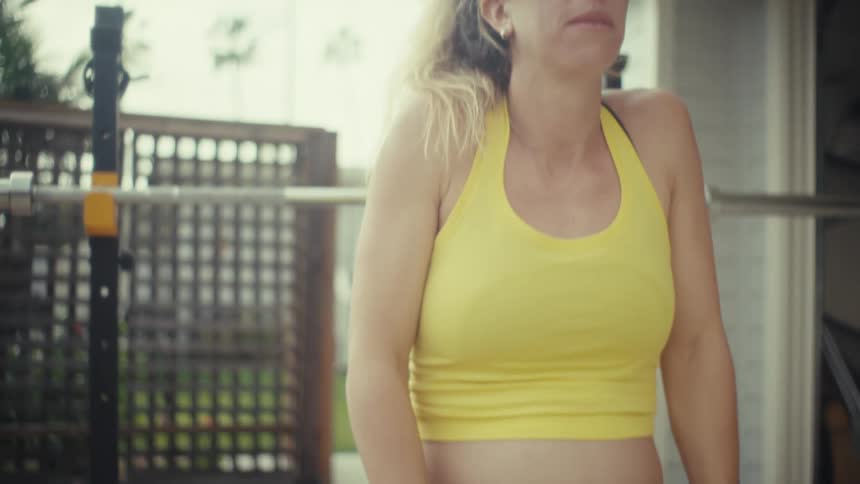 Pregnant woman performing a bench press exercise on strength training equipment