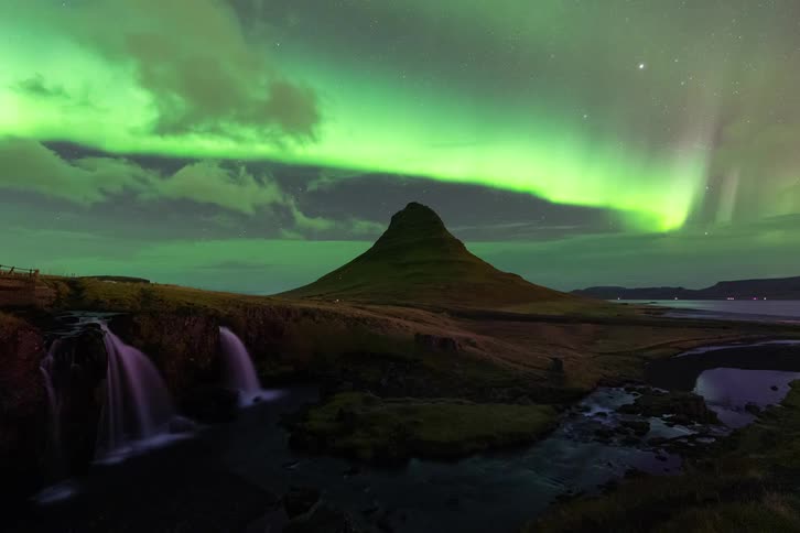 A time lapse of the aurora over a hill