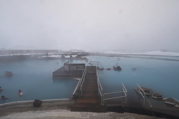 People in the water of a hot spring on a winter day