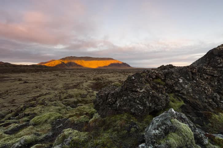 The sun setting over a rocky landscape