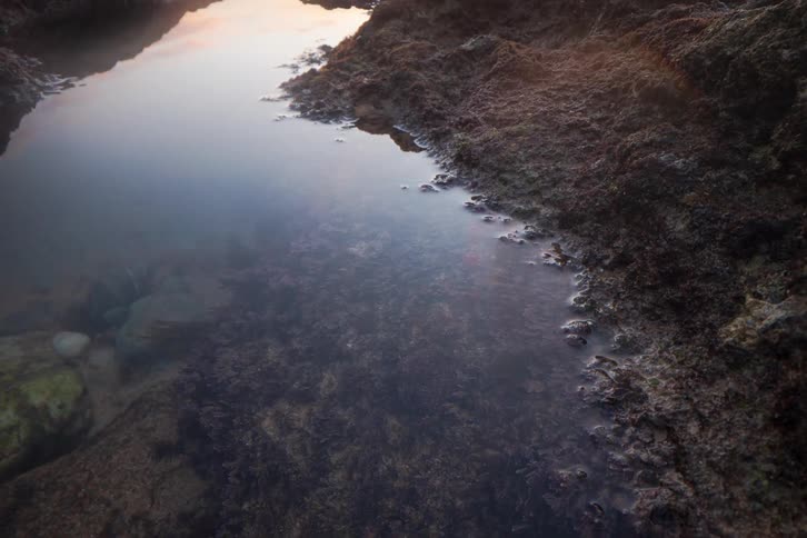 A time lapse of the sun setting over the coast