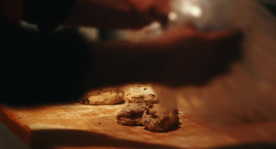 A chef in the kitchen making dough on a table