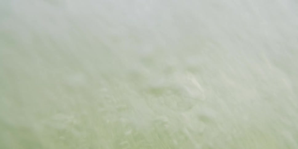 A shirtless figure twists midair as he plunges into a river motion blur and splashing water capturing the split second between flight and impact