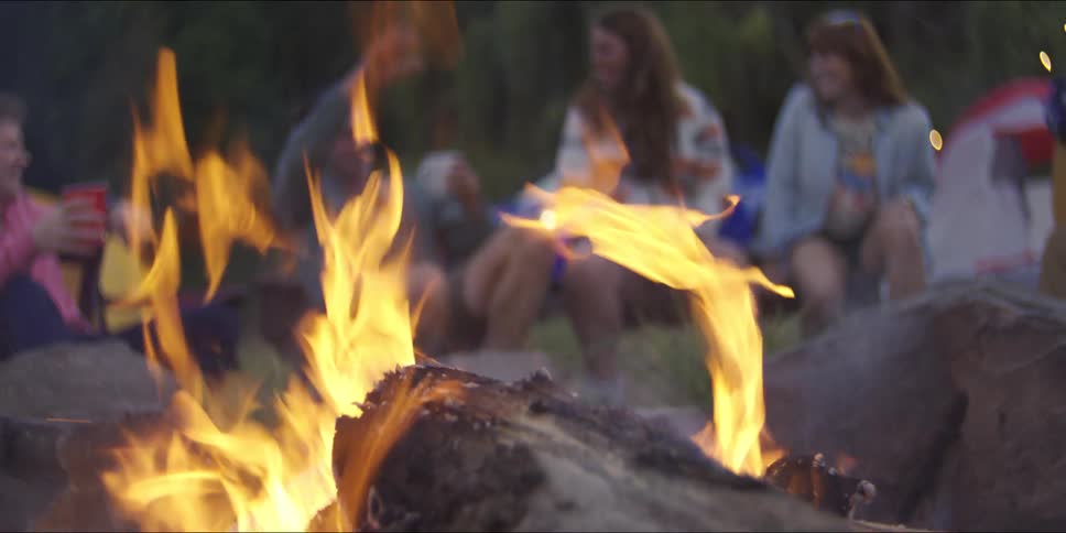 A group of people out near a campfire