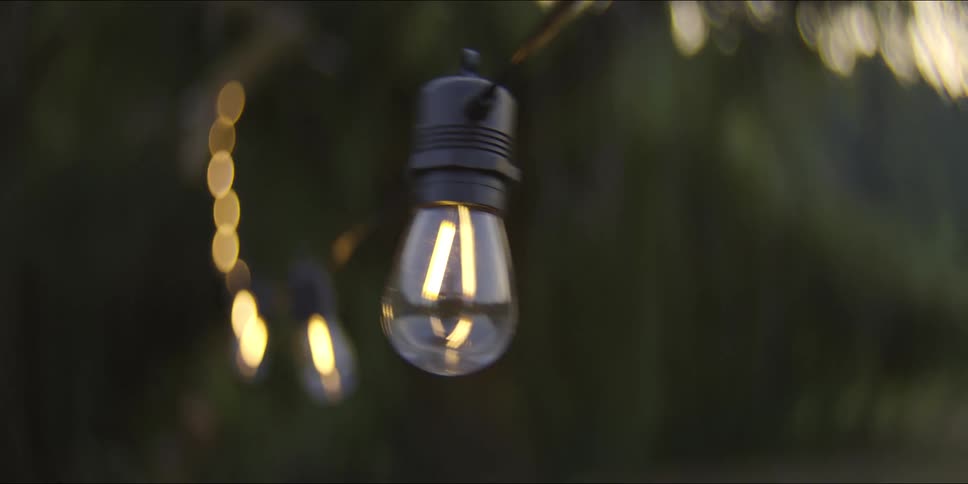Some lights hanging from a string outdoors