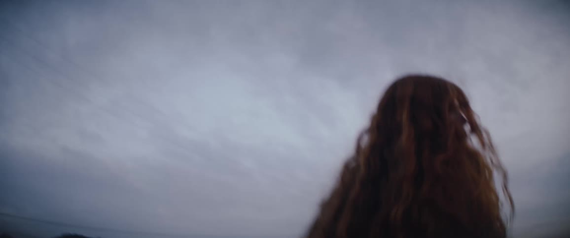 A woman outdoors on a cloudy day
