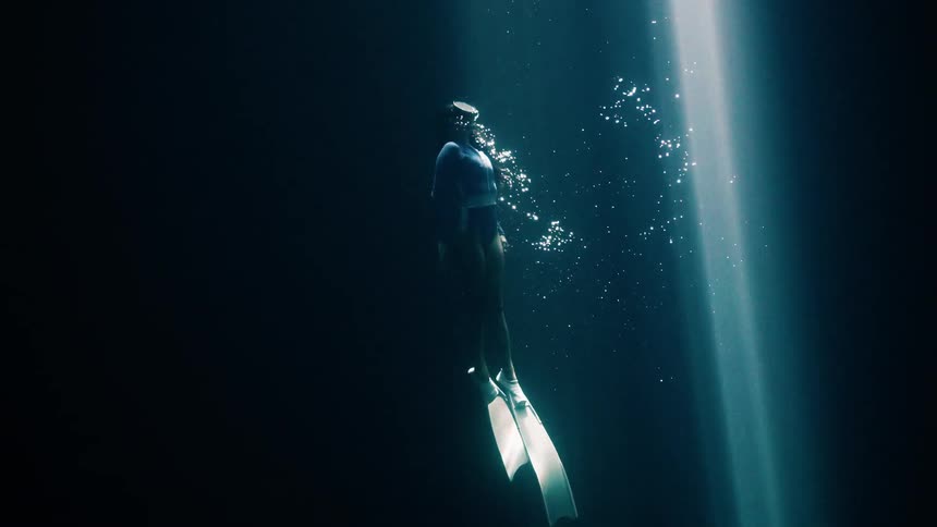 A woman swimming underwater