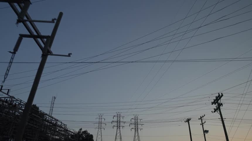Telephone poles and wires at sunset