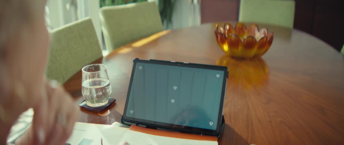 The woman is looking at her tablet