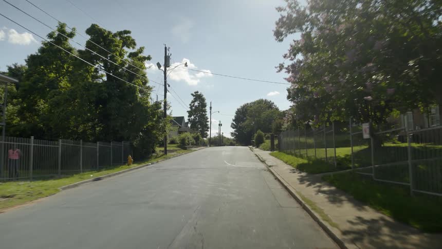 Traveling view going down a city neighborhood
