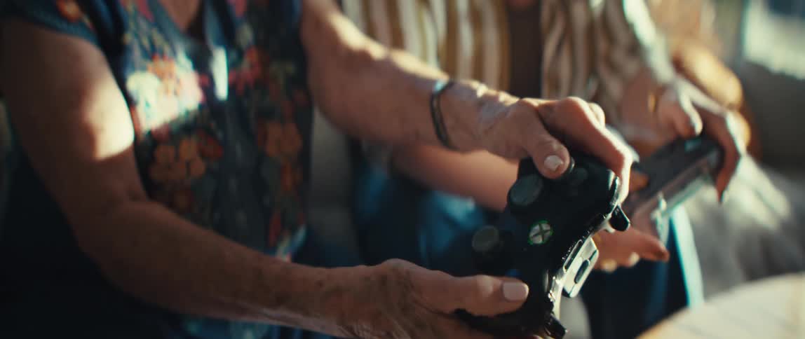 The women press buttons fast on the video game controllers
