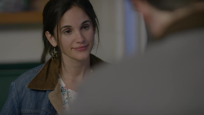 Woman sits and talks with a man