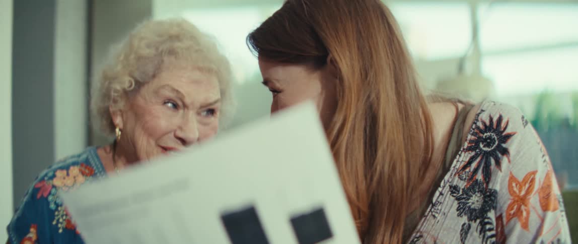 Two women talking and looking at a piece of paper