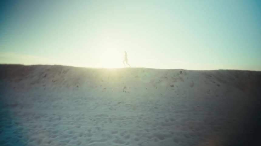 A woman running down a beach