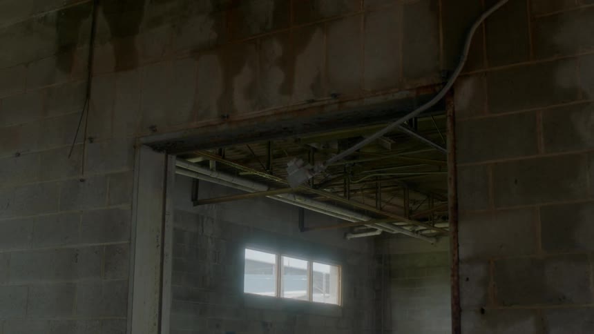 The hall leads to a small window ahead