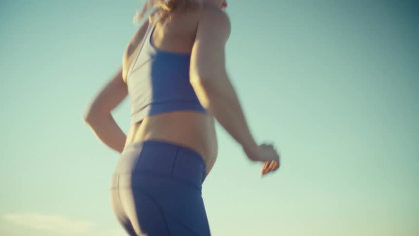 A woman running outdoors on a sunny day