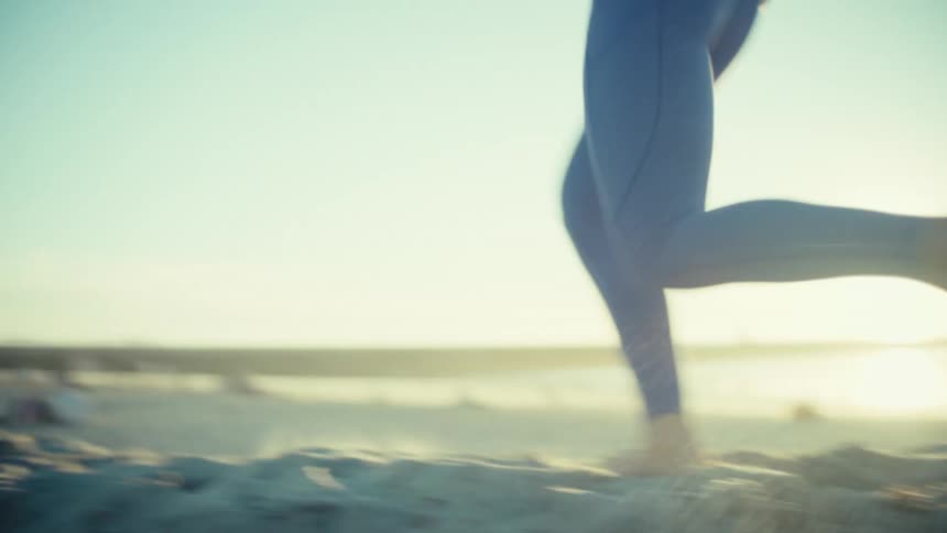 A woman running on some sand