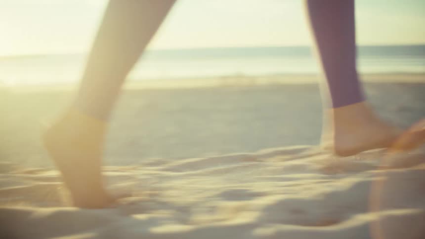 A woman running outdoors on the beach