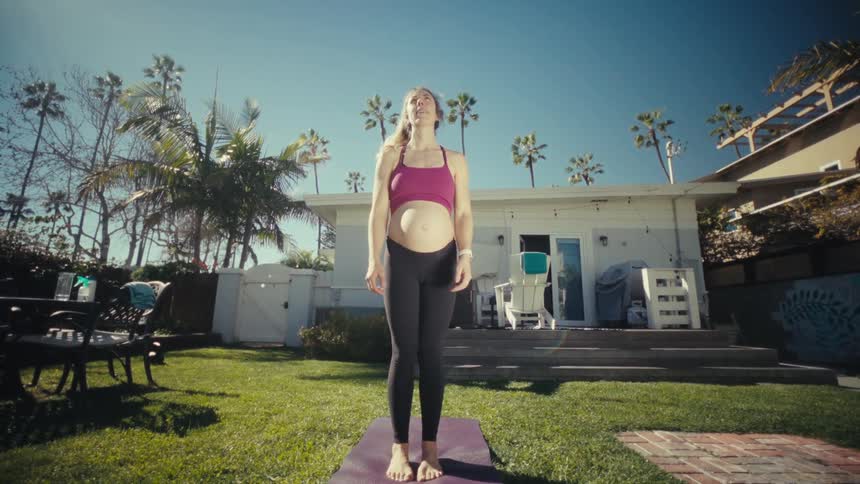 A woman doing stretching on a yoga mat