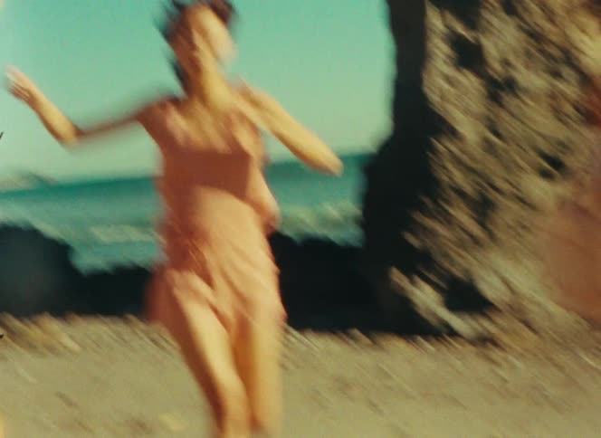 Three young females wearing beachwear clothing running and smiling at the beach next to the ocean outdoors during day time