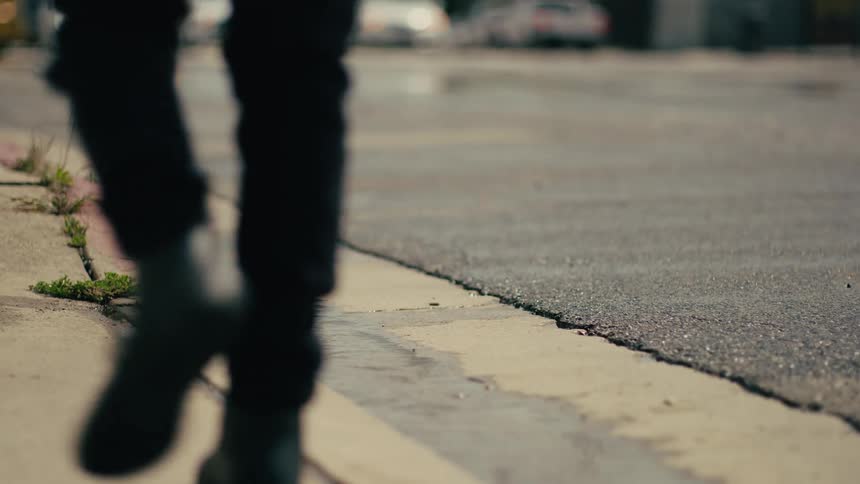 A person walking next to a street
